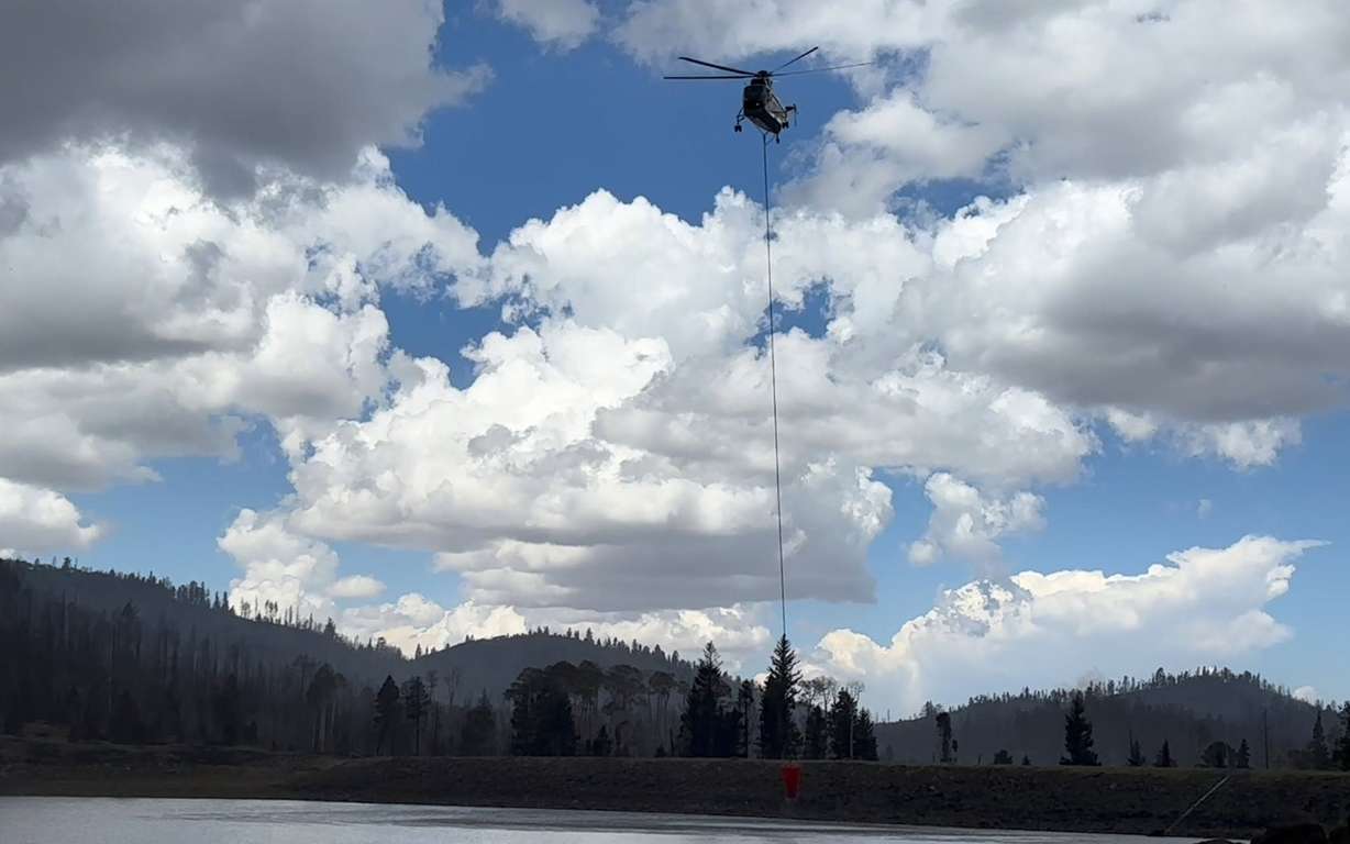 A helicopter dipping out of Kents Lake on Thursday, June 25, 2026, while fighting the Cottonwood Fire.