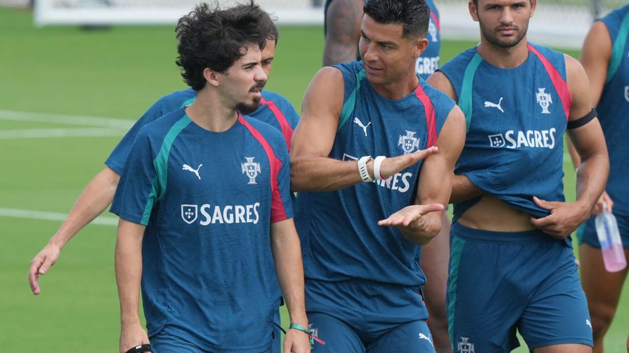 Portugal's Cristiano Ronaldo, center talks to Vitinha during the men's national soccer team World Cup training session Thursday, June 25, 2026, in Palm Beach Gardens, Fla.