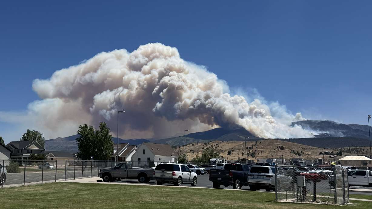 Smoke from the Cottonwood Fire visible over the mountains, sending dark smoke high into the air on Friday.