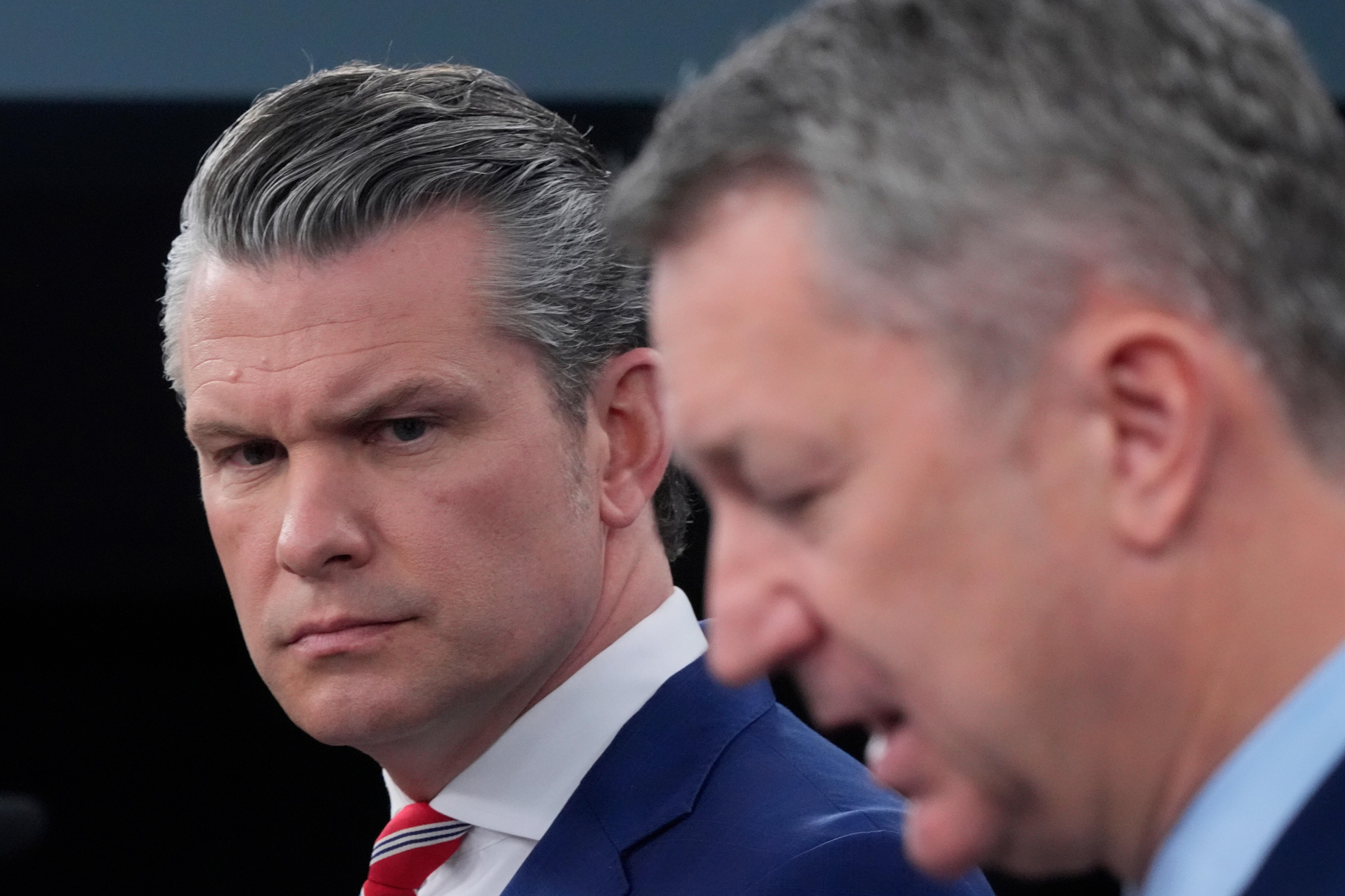 Defense Secretary Pete Hegseth and Chairman of the Joint Chiefs of Staff Gen. Dan Caine speak to members of the media during a press briefing at the Pentagon in Washington, May 5. Hegseth's approval rating in Utah has dropped after controversy over the Pentagon's new religious affiliations list.