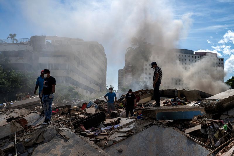 Rescuers and volunteers search for survivors in La Guaira, La Guaira state, Venezuela, on Sunday, following earthquakes.