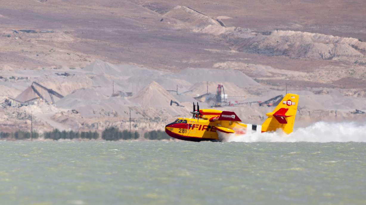 A Canadair CL-415 Super Scooper refills its water tank in Utah Lake near Elberta on Sunday.