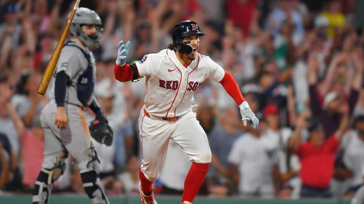 Boston Red Sox's Jarren Duran, right, celebrates in front of New York Yankees catcher Austin Wells, left, after hitting a walk-off one-run single in the tenth inning of a baseball game, Sunday, June 28, 2026, in Boston.