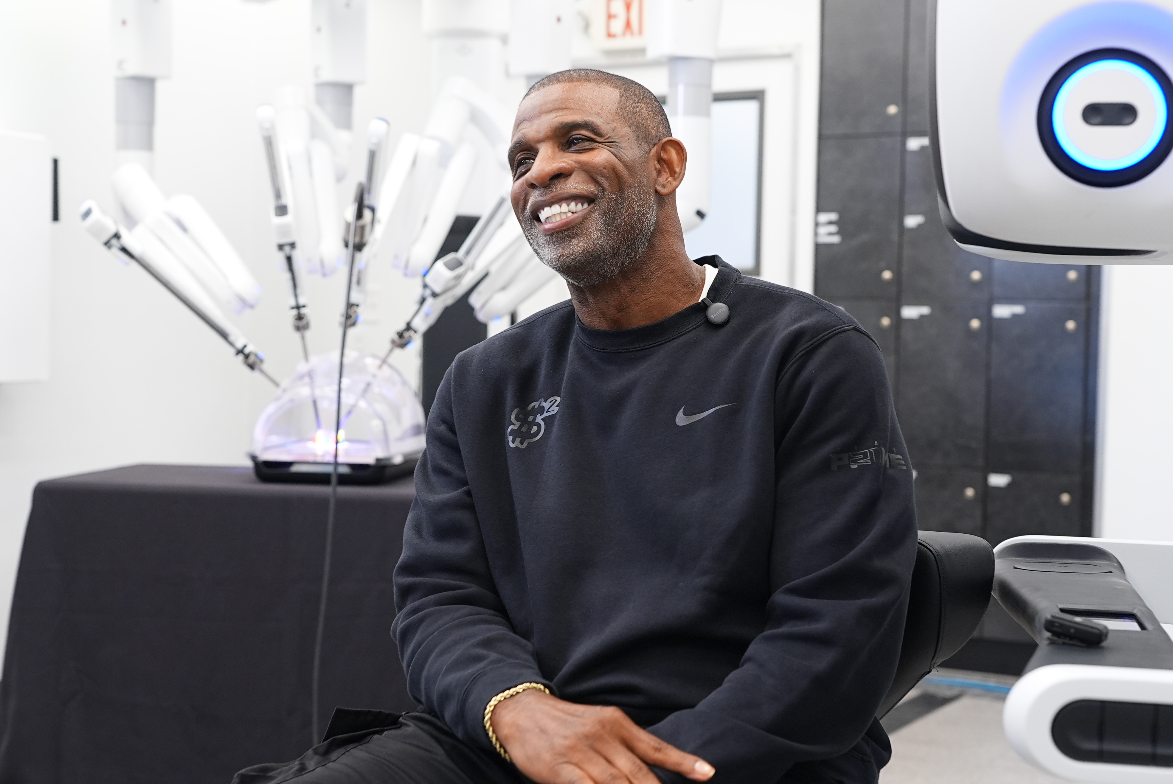 Colorado head football coach Deion Sanders talks about working the Da Vinci robotic surgical machine used to remove his cancerous bladder last year during a demonstration of the device Tuesday, June 23, 2026, in Boulder, Colo. 
