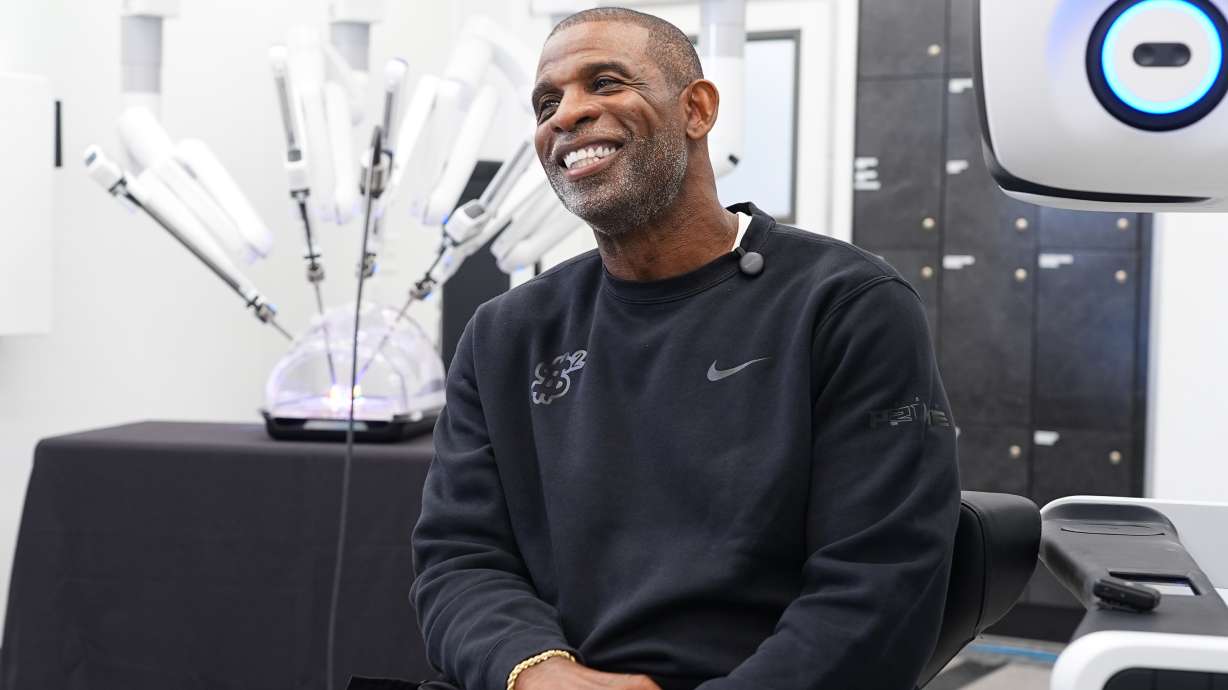 Colorado head football coach Deion Sanders talks about working the Da Vinci robotic surgical machine used to remove his cancerous bladder last year during a demonstration of the device Tuesday, June 23, 2026, in Boulder, Colo.