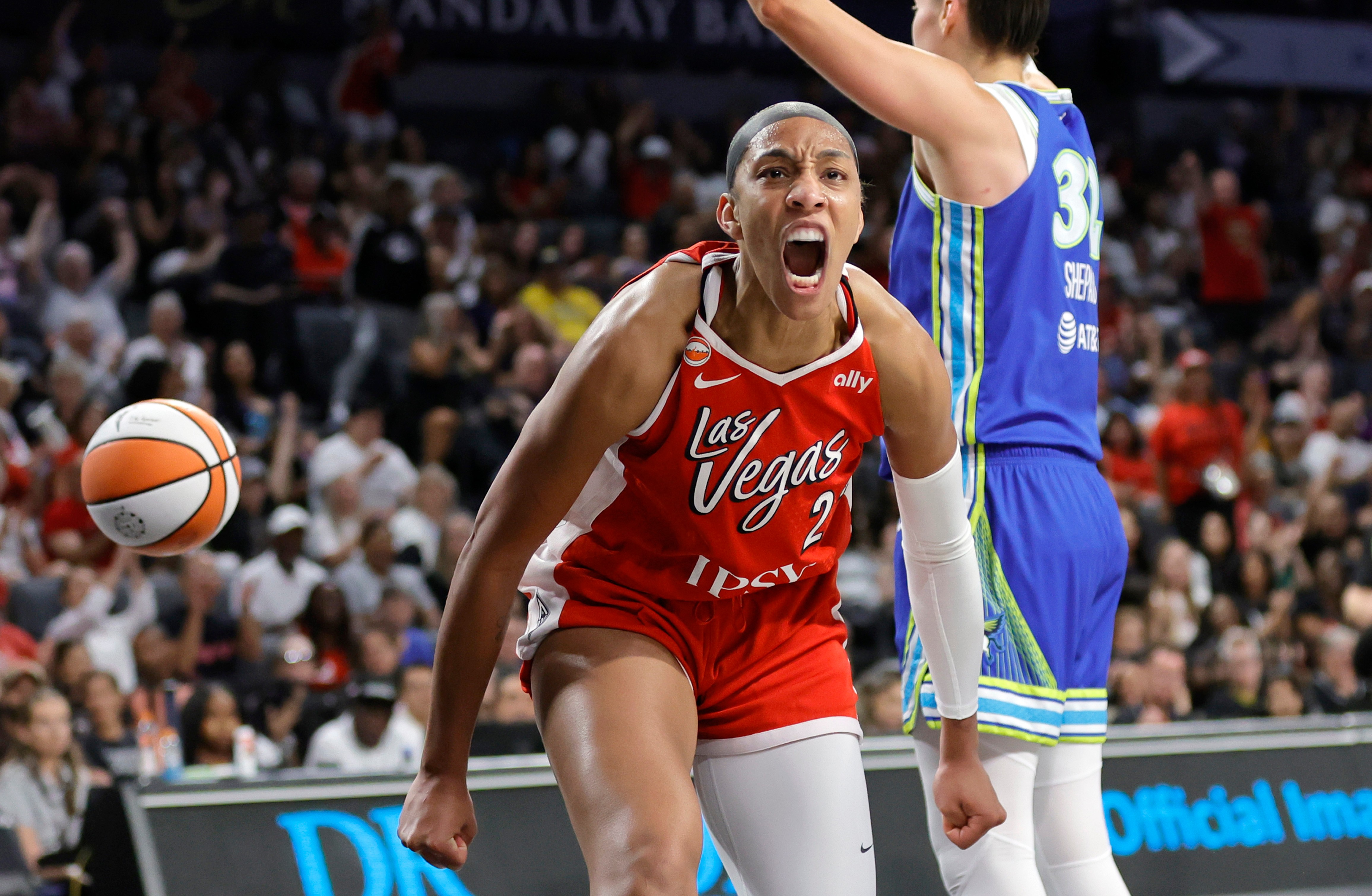 Las Vegas Aces center A'ja Wilson, left, reacts after scoring against Dallas Wings forward Jessica Shepard, right, during the first half of a WNBA basketball game Thursday, June 25, 2026, in Las Vegas. 