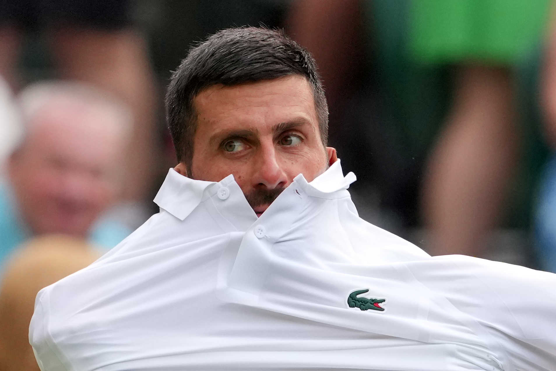 Novak Djokovic of Serbia changes his shirt during the men's singles match against Yibing Wu of China at the Wimbledon Tennis Championships in London, Monday, June 29, 2026.