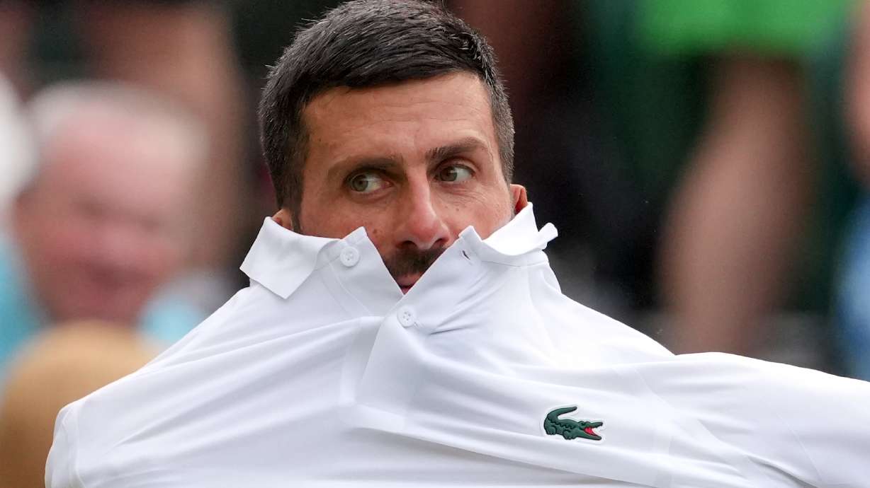 Novak Djokovic of Serbia changes his shirt during the men's singles match against Yibing Wu of China at the Wimbledon Tennis Championships in London, Monday, June 29, 2026.