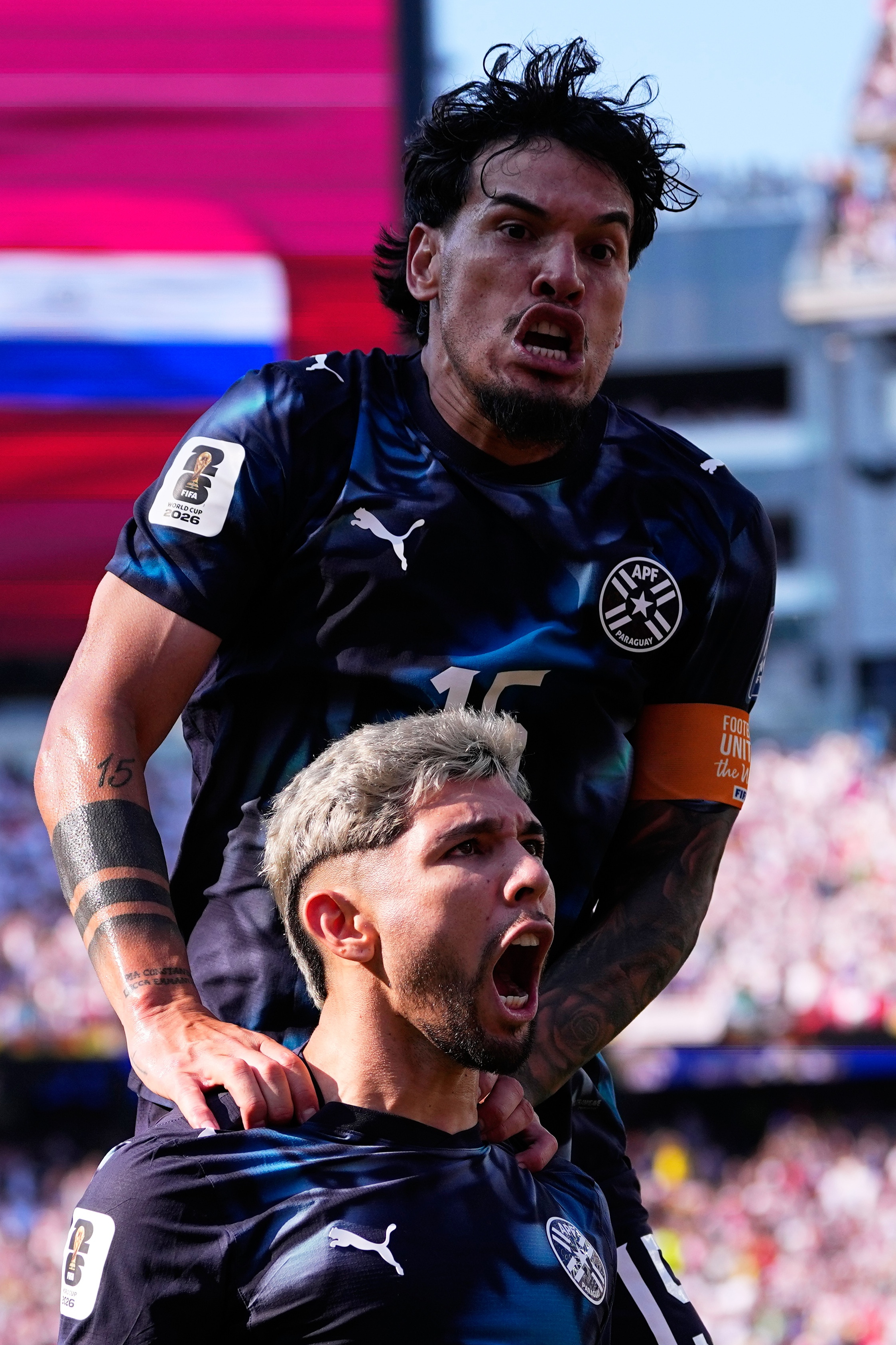 Paraguay's Julio Enciso (19) celebrates after scoring his side's opening goal with Gustavo Gomez (15), top, during the World Cup round of 32 soccer match between Germany and Paraguay in Foxborough, Mass., near Boston, Monday, June 29, 2026. 