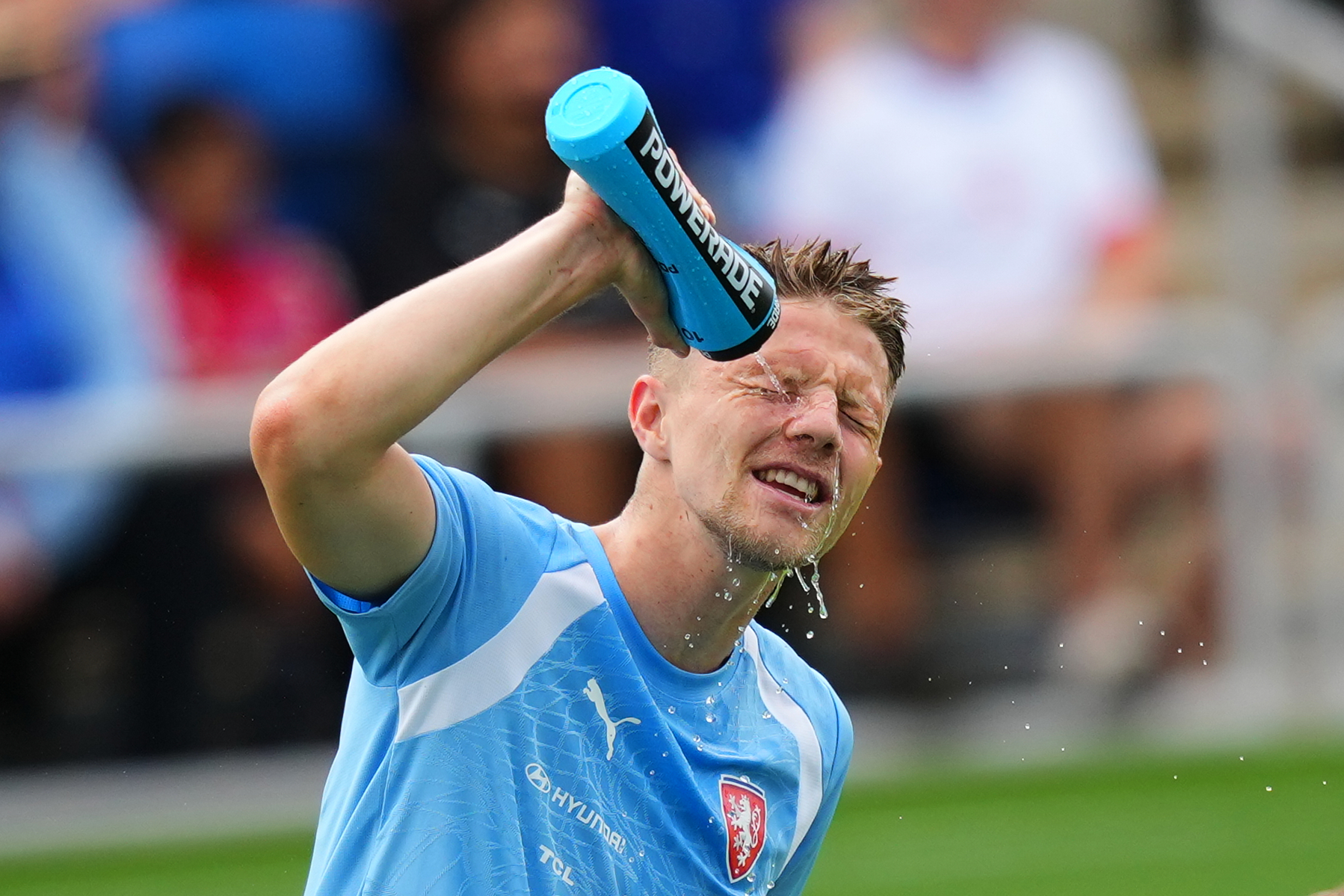 Lukas Cerv, of the Czechia men's national soccer team, refreshes himself while working out in hot Texas weather during a public training session, Saturday, June 6, 2026, in Mansfield, Texas, ahead of the World Cup soccer tournament. 