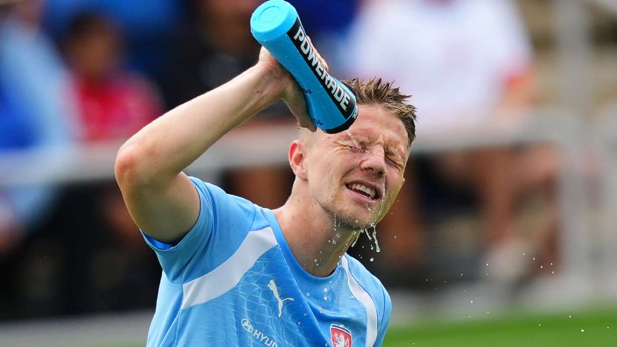 Lukas Cerv, of the Czechia men's national soccer team, refreshes himself while working out in hot Texas weather during a public training session, Saturday, June 6, 2026, in Mansfield, Texas, ahead of the World Cup soccer tournament.