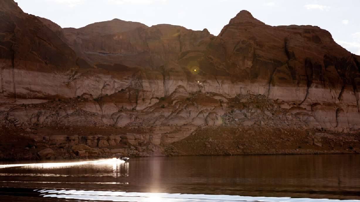 A boat is seen against the backdrop of Lake Powell's "bathtub ring" on Oct. 7, 2022, near Bullfrog. Authorities with the National Park Service recovered the body of a man who drowned at Lake Powell Saturday morning.
