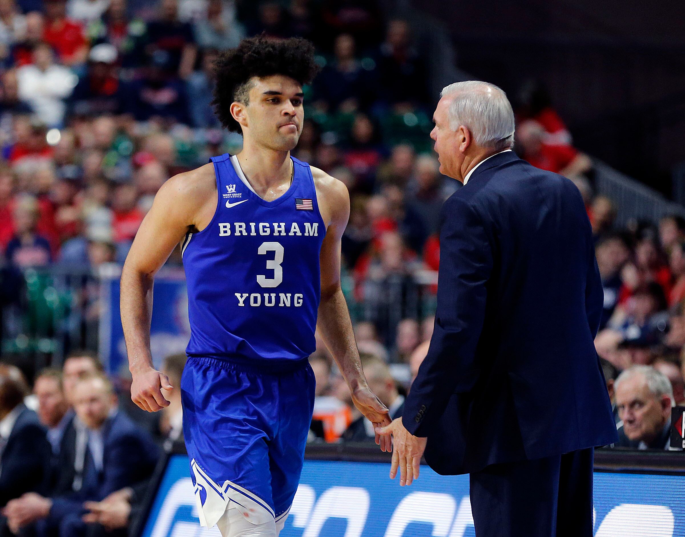 Brigham Young guard Elijah Bryant walks by head coach Dave Rose as he comes out near the end of the game against the Gonzaga Bulldogs during the West Coast Conference championship game in Las Vegas on March 6, 2018.