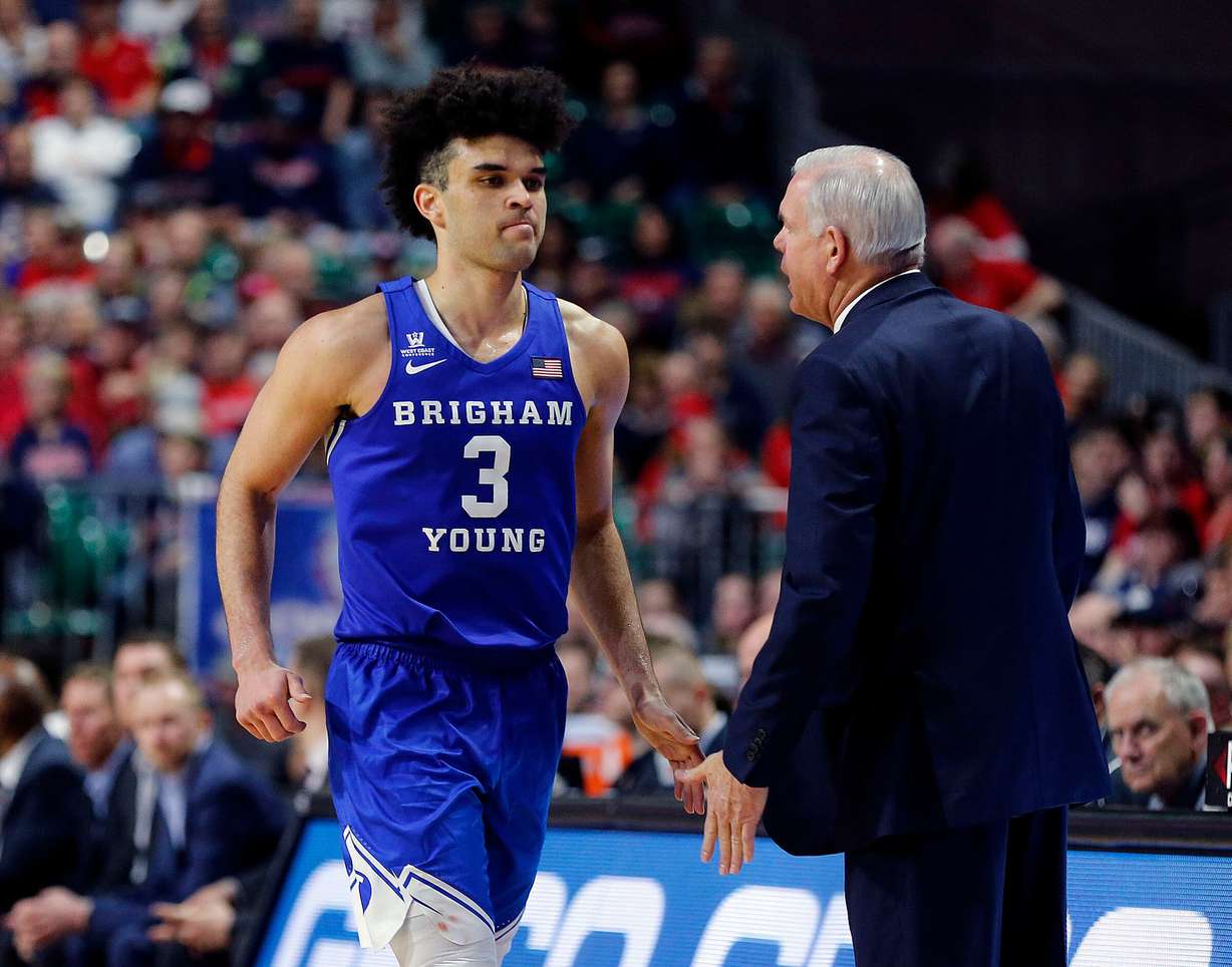 Brigham Young guard Elijah Bryant walks by head coach Dave Rose as he comes out near the end of the game against the Gonzaga Bulldogs during the West Coast Conference championship game in Las Vegas on March 6, 2018.