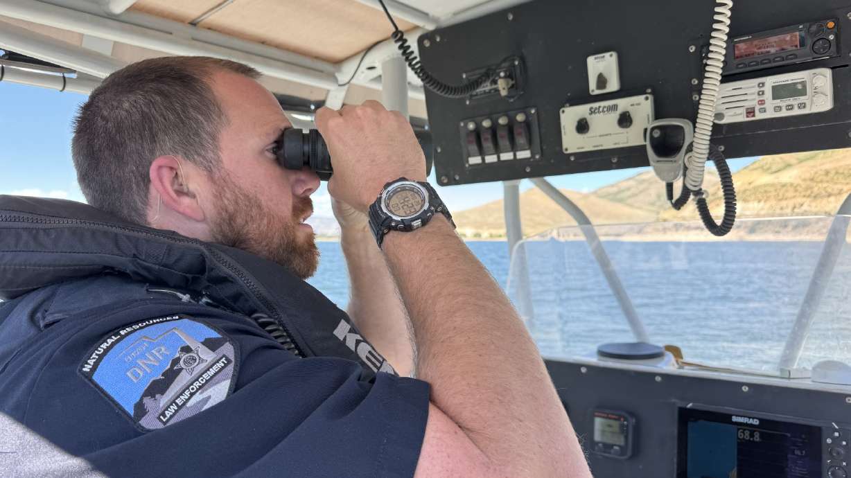 Utah DNR Division of Law Enforcement Ranger Chris Nelson surveys Deer Creek Reservoir on Monday.