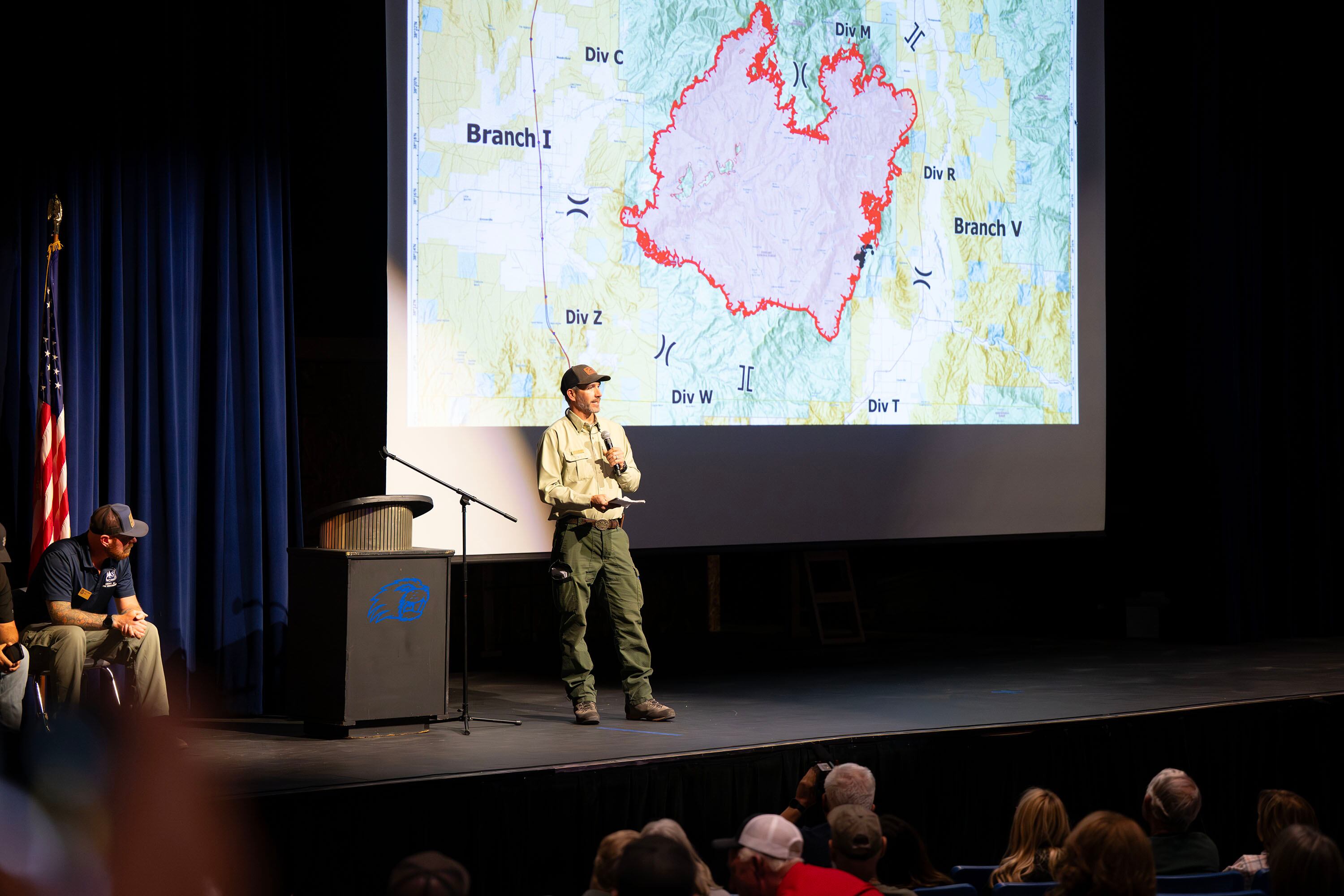 Jared Whitmer, a Forest Service district ranger, speaks during a community meeting at Beaver High School on Monday. The Cottonwood Fire continues to burn on the mountains east of the town.