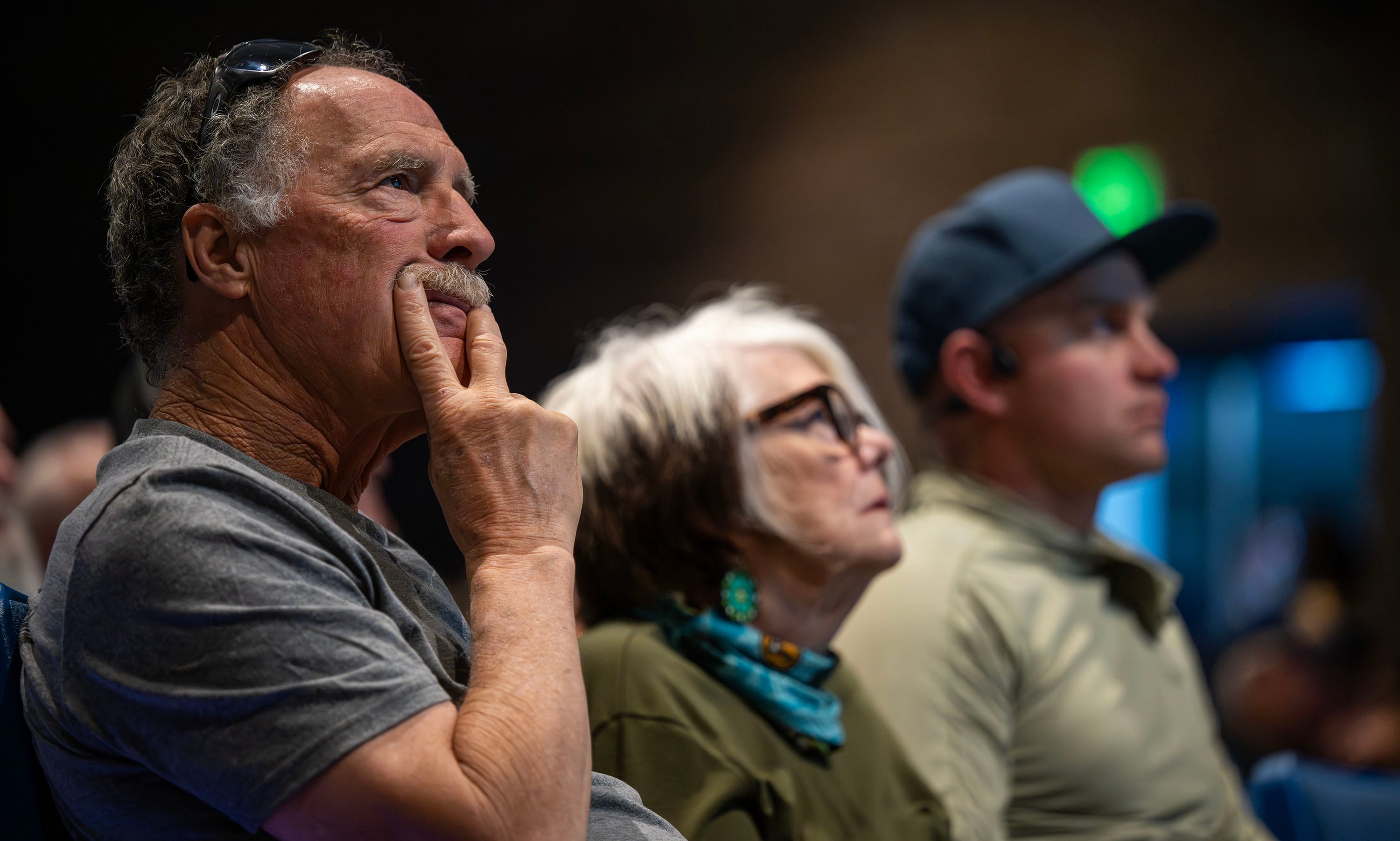 Lynn Jenkins, Pamela McCue and Tanner Larsen listen during a community meeting discussing the Cottonwood Fire burning on the mountains east of Beaver on Monday. The fire has torched over 94,000 acres and is just 4% contained.