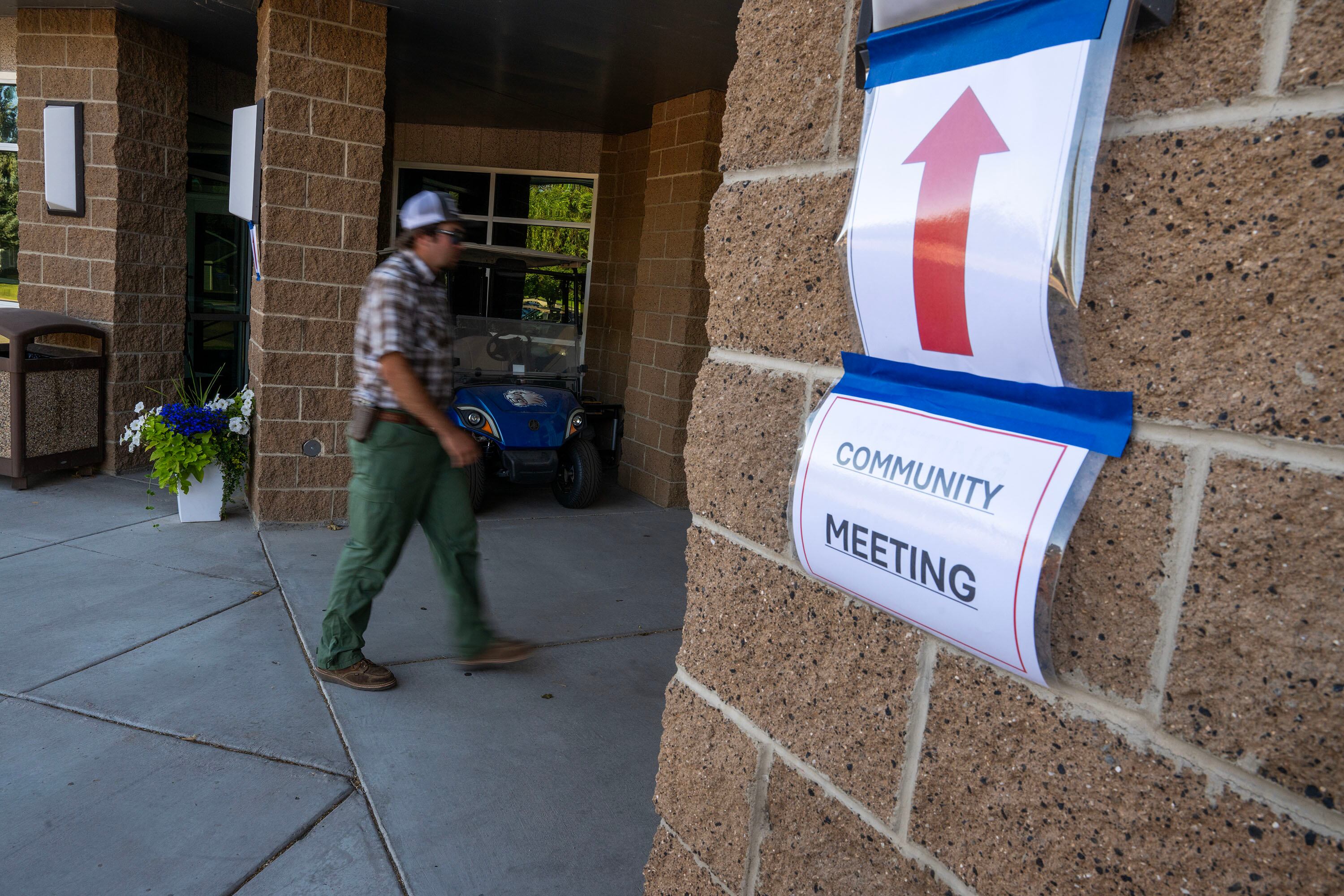 A man walks into Beaver High School for a community meeting discussing the Cottonwood Fire, which is burning on the mountains east of Beaver, on Monday. One-third of the town's residents were at the meeting.