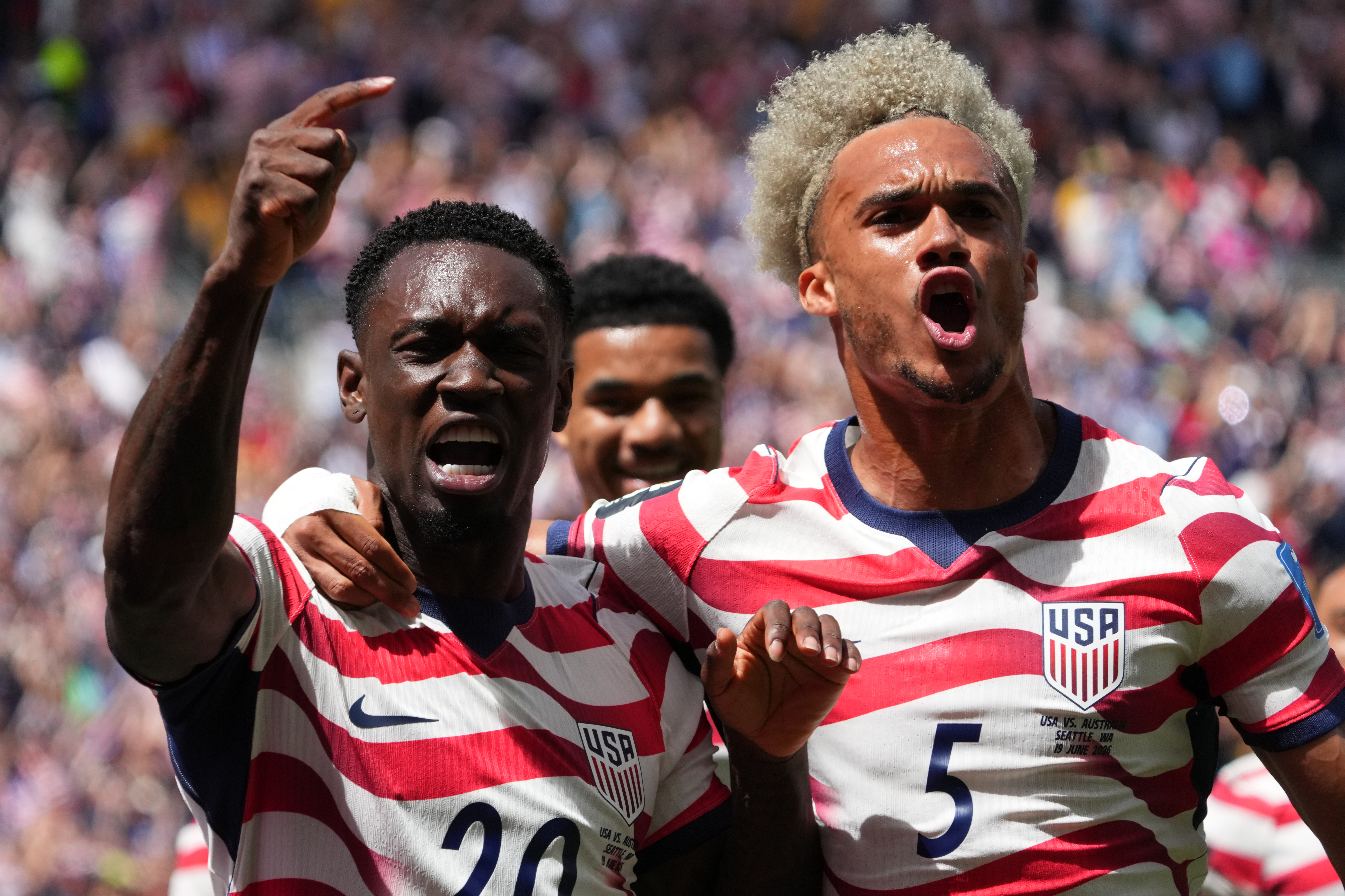 United States' Folarin Balogun (20) and Antonee Robinson (5) celebrate after scoring during the World Cup Group D soccer match between the United States and Australia in Seattle, Friday, June 19, 2026. 