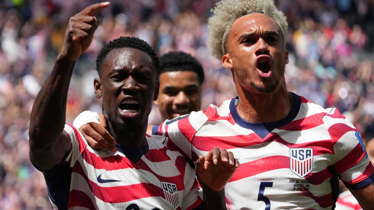 United States' Folarin Balogun (20) and Antonee Robinson (5) celebrate after scoring during the World Cup Group D soccer match between the United States and Australia in Seattle, Friday, June 19, 2026.