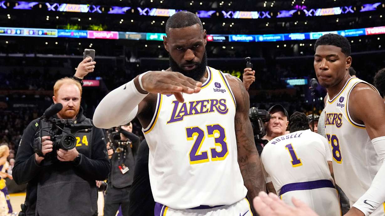 FILE - Los Angeles Lakers forward LeBron James salutes public address announcer Lawrence Tanter prior to an NBA basketball game against the Denver Nuggets Saturday, March 2, 2024, in Los Angeles.