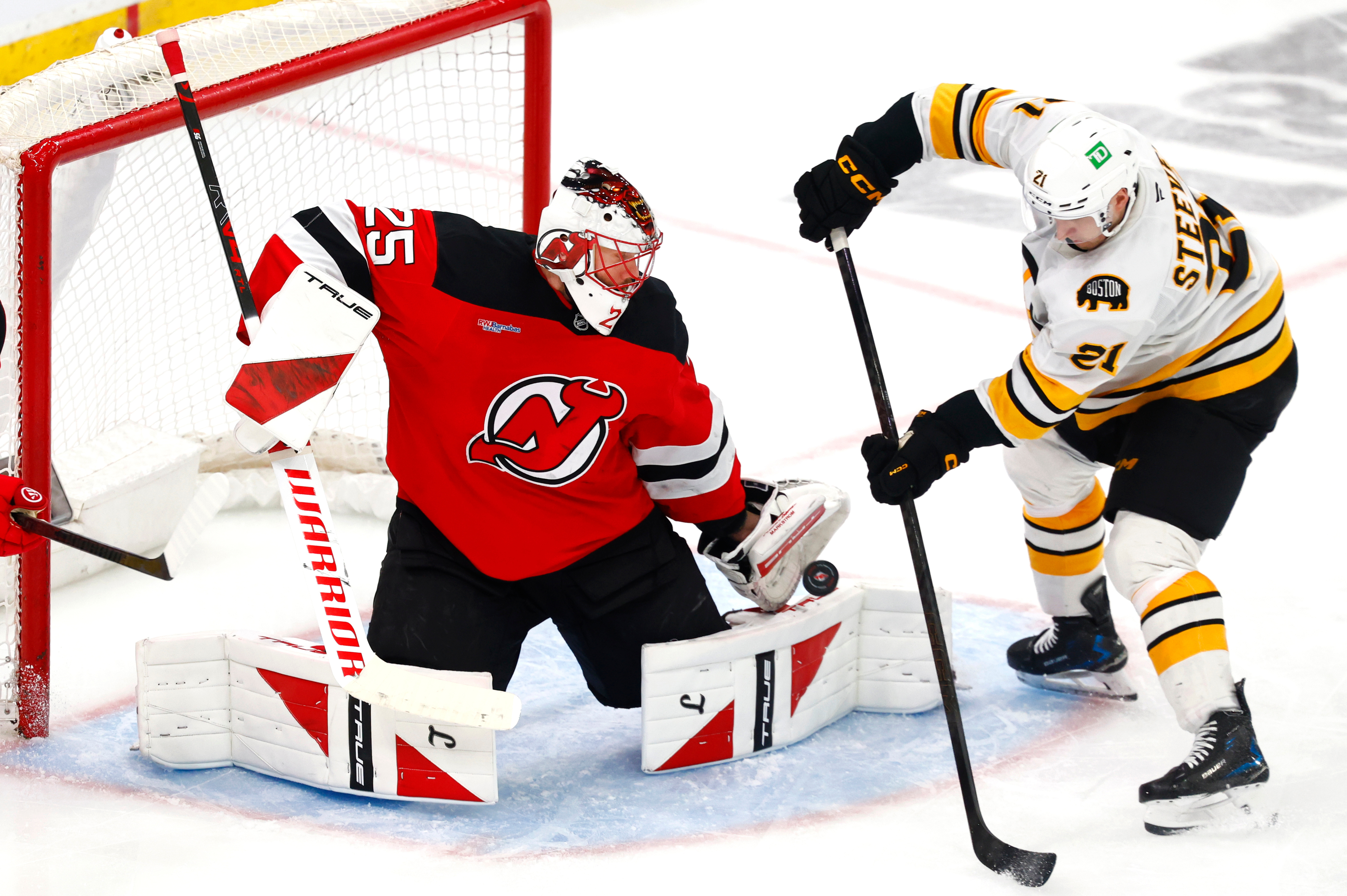 FILE - New Jersey Devils goaltender Jacob Markstrom (25) makes a save against Boston Bruins forward Alex Steeves (21) during the third period of an NHL hockey game, March 16, 2026, in Newark, N.J. 