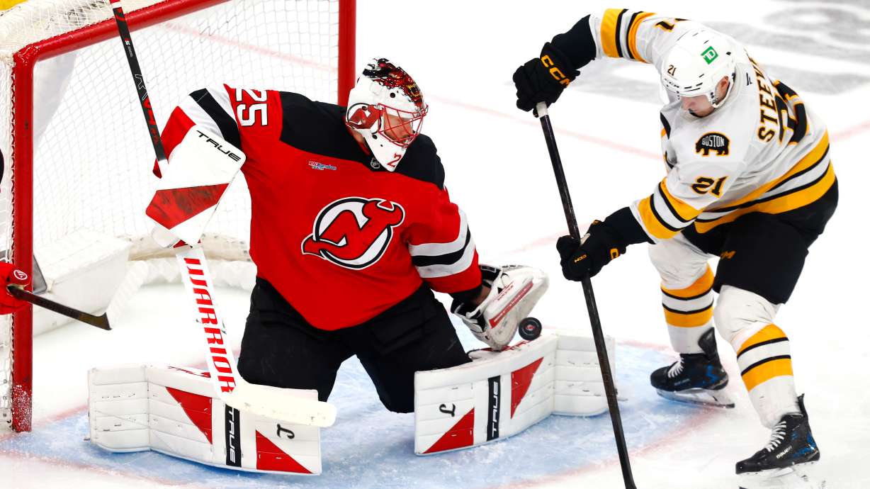 FILE - New Jersey Devils goaltender Jacob Markstrom (25) makes a save against Boston Bruins forward Alex Steeves (21) during the third period of an NHL hockey game, March 16, 2026, in Newark, N.J.
