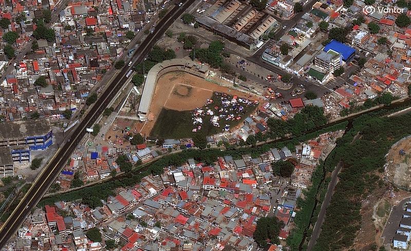 A satellite image shows tents and shelters for first responders at the baseball field Forum de La Guaira, in La Guaira, Venezuela, Monday. The damage can be seen from space.