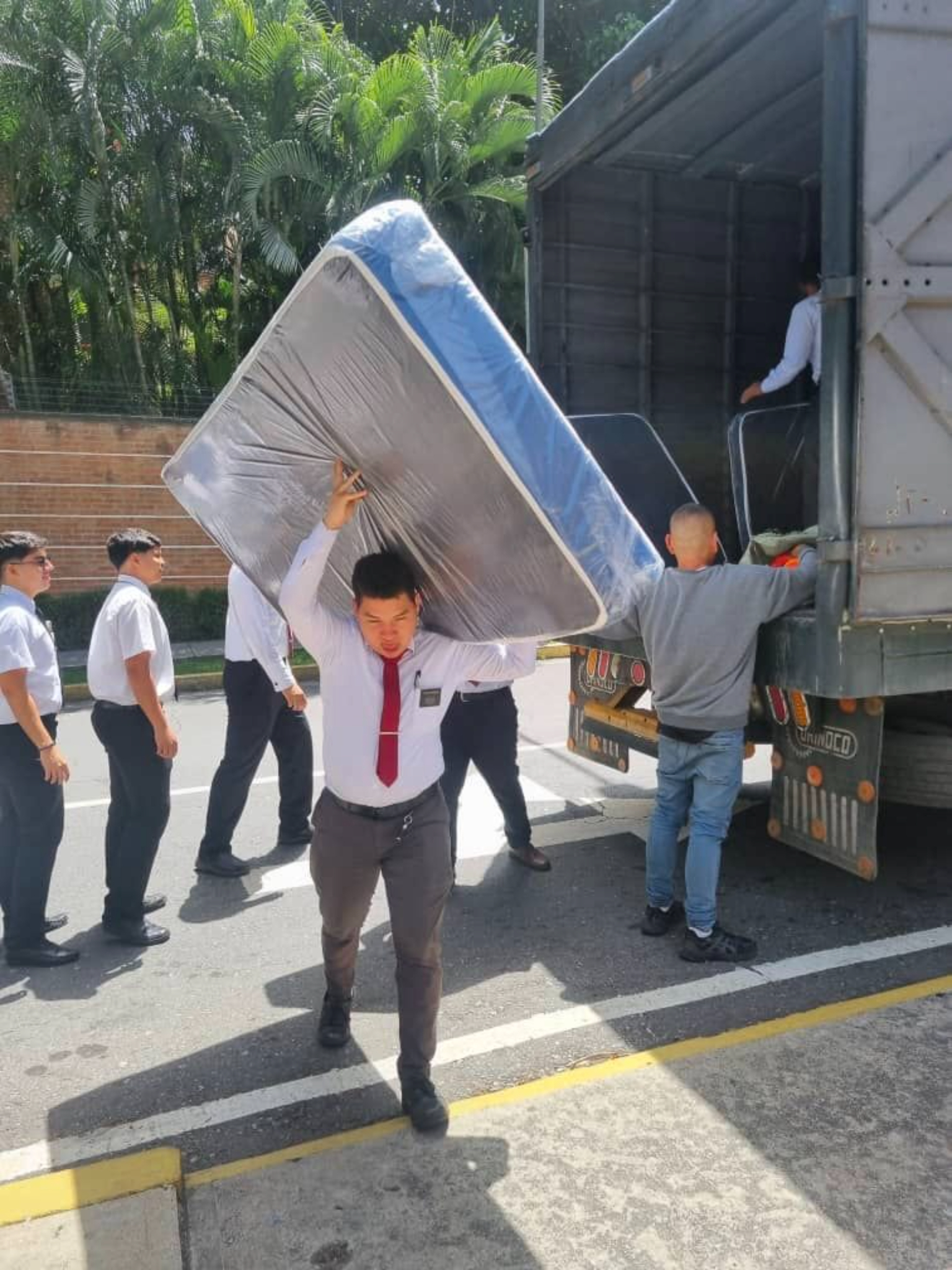 A missionary carries a mattress as part of the church's efforts to mobilize humanitarian aid for more than 23,500 people affected by the June 24 earthquakes in Venezuela.