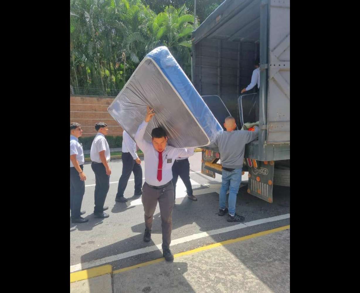A missionary carries a mattress as part of the church's efforts to mobilize humanitarian aid for more than 23,500 people affected by the June 24 earthquakes in Venezuela.