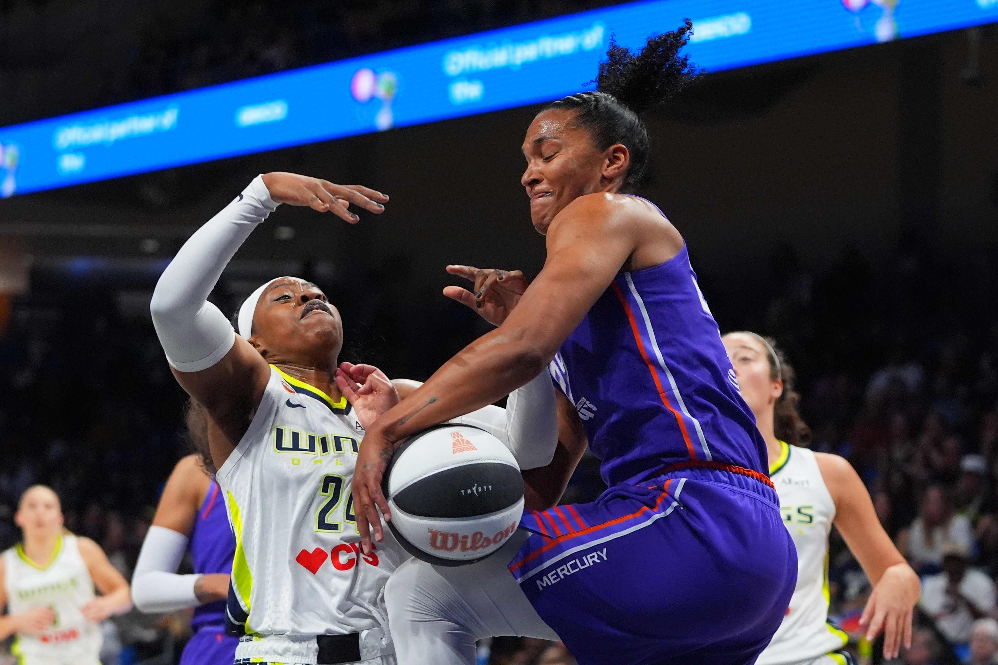 Phoenix Mercury forward Alyssa Thomas (25) strips the ball from Dallas Wings guard Arike Ogunbowale (24) during the first half of a WNBA basketball game in Arlington, Texas, Thursday, June 11, 2026. 