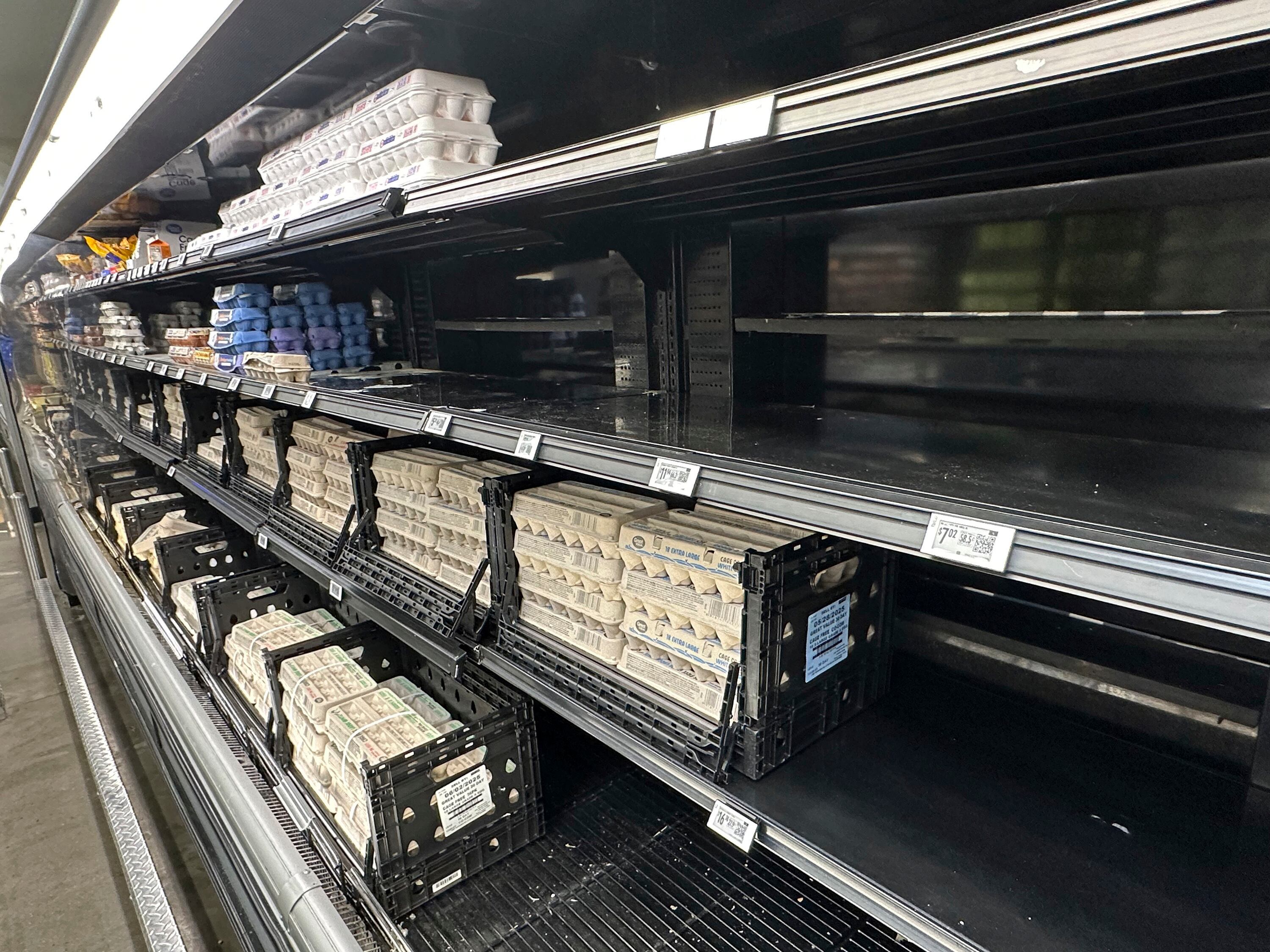 Empty spaces dot the egg display in a Walmart store Tuesday, May 13, 2025, in Englewood, Colo.