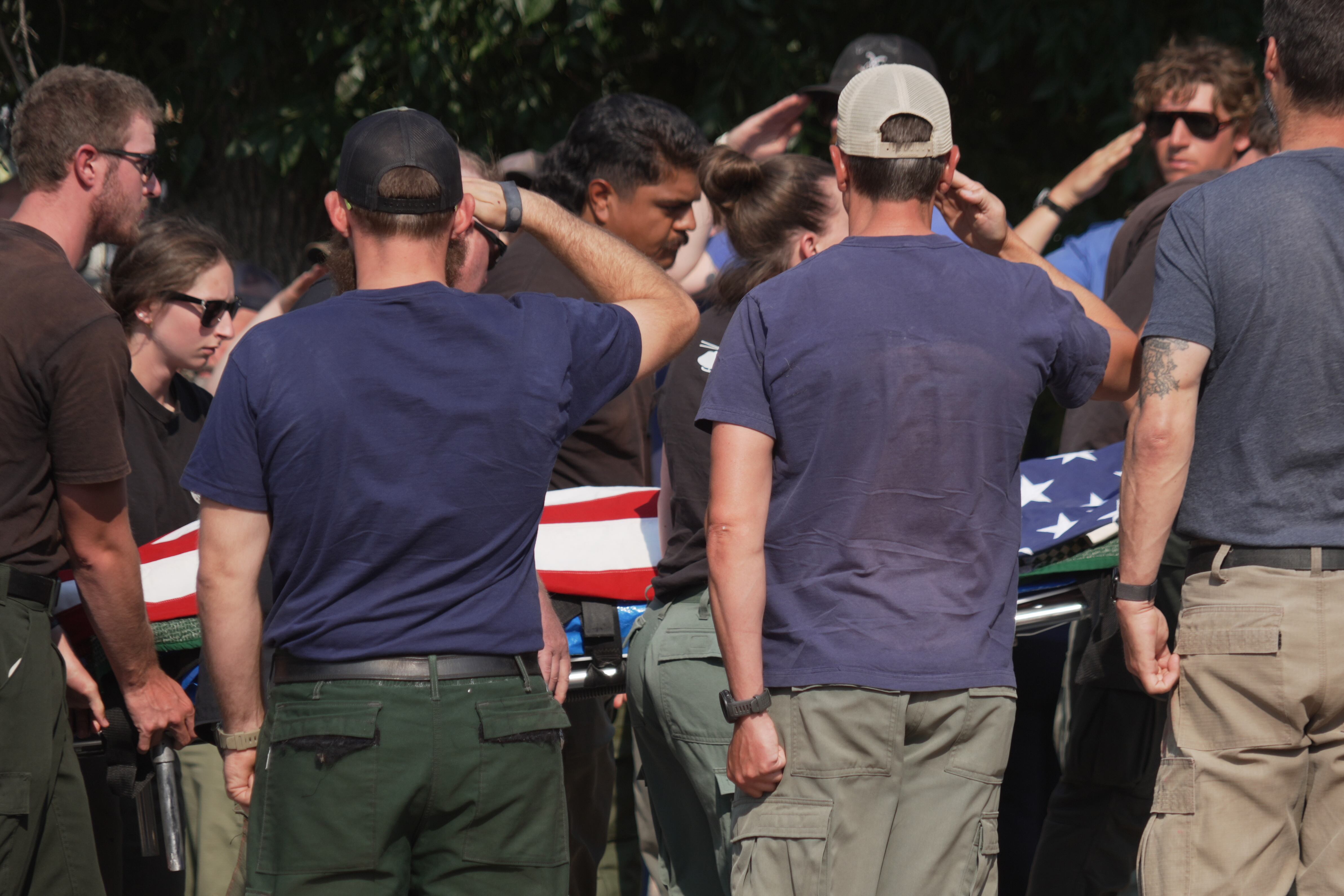 The body of a firefighter who died battling wildfires near the Colorado-Utah border is carried during a procession in Grand Junction, Colo., Monday. Three firefighters were killed and two more were injured in the Snyder Fire.