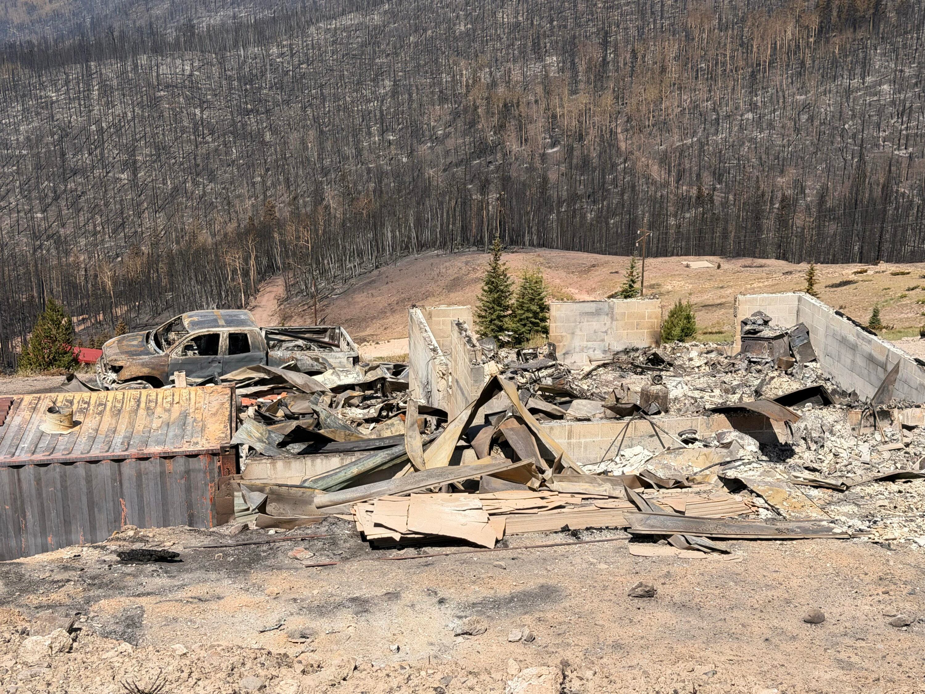 Charred remains of houses and vehicles in Eagle Point Resort’s West Village outside of Beaver, Tuesday, after the Cottonwood Fire torched much of the area. Matt Clarke is one of the residents who lost property in the fire.