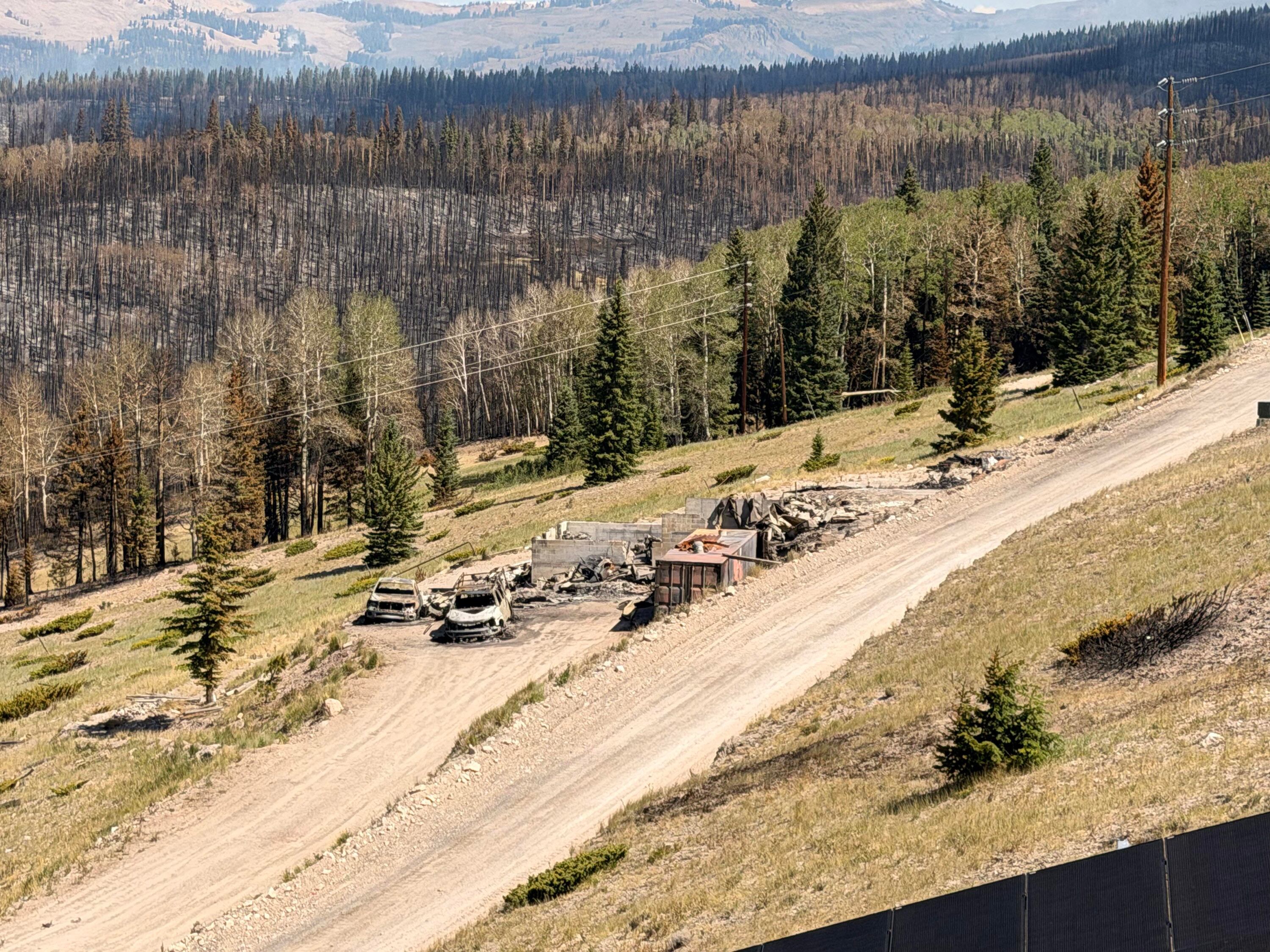 Charred remains of houses and vehicles in Eagle Point Resort’s West Village outside of Beaver, Tuesday, after the Cottonwood Fire torched much of the area. The fire has destroyed over 150 structures so far.
