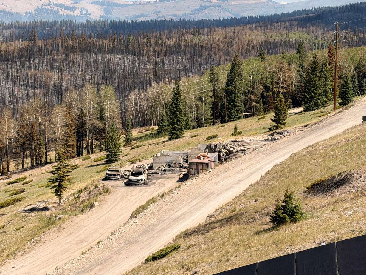 Charred remains of houses and vehicles in Eagle Point Resort’s West Village outside of Beaver, Tuesday, after the Cottonwood Fire torched much of the area. The fire has destroyed over 150 structures so far.