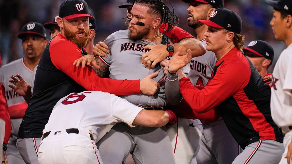 Washington Nationals' Andrés Chaparro, center, is held back as tempers flare during the fourth inning of a baseball game against the Boston Red Sox, Tuesday, June 30, 2026, in Boston.