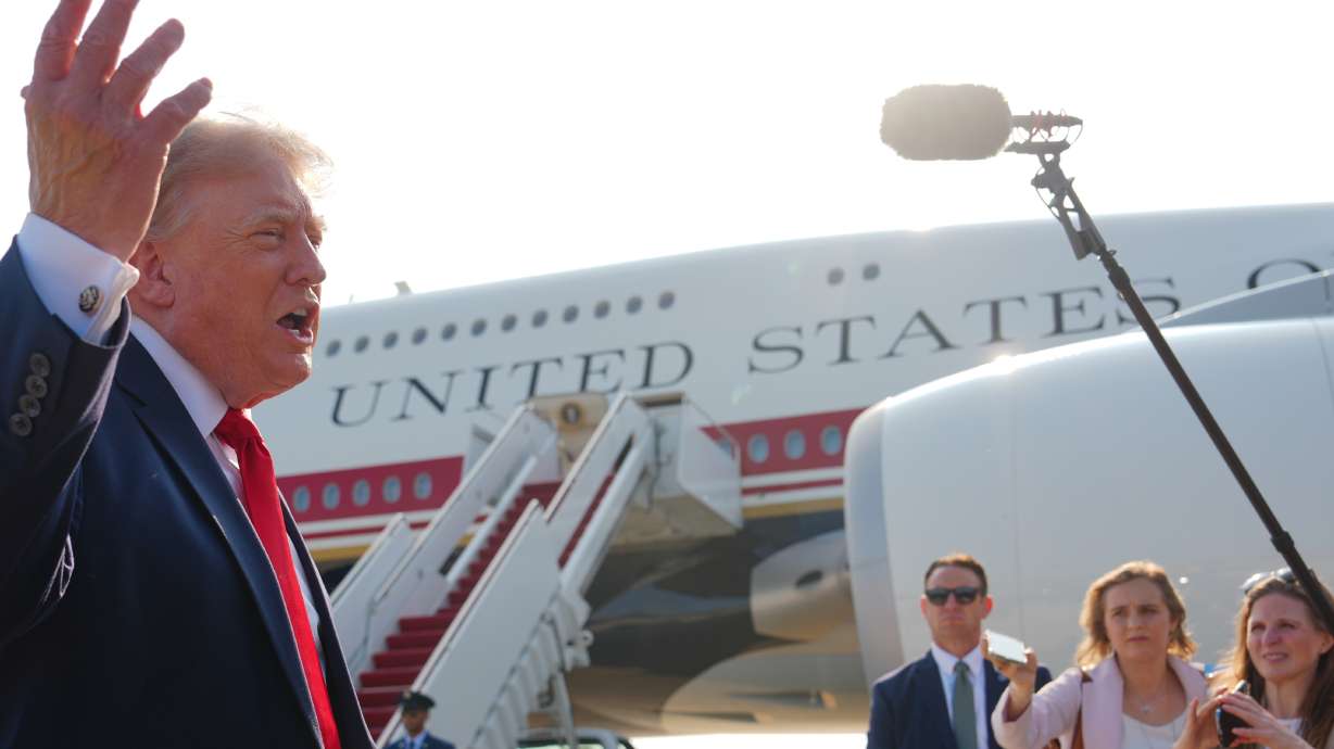 President Donald Trump speaks to reporters before boarding the new Air Force One, Wednesday, at Joint Base Andrews, Md. The new Air Force One is a retrofitted Boeing 747 worth $400 million gifted by Qatar.