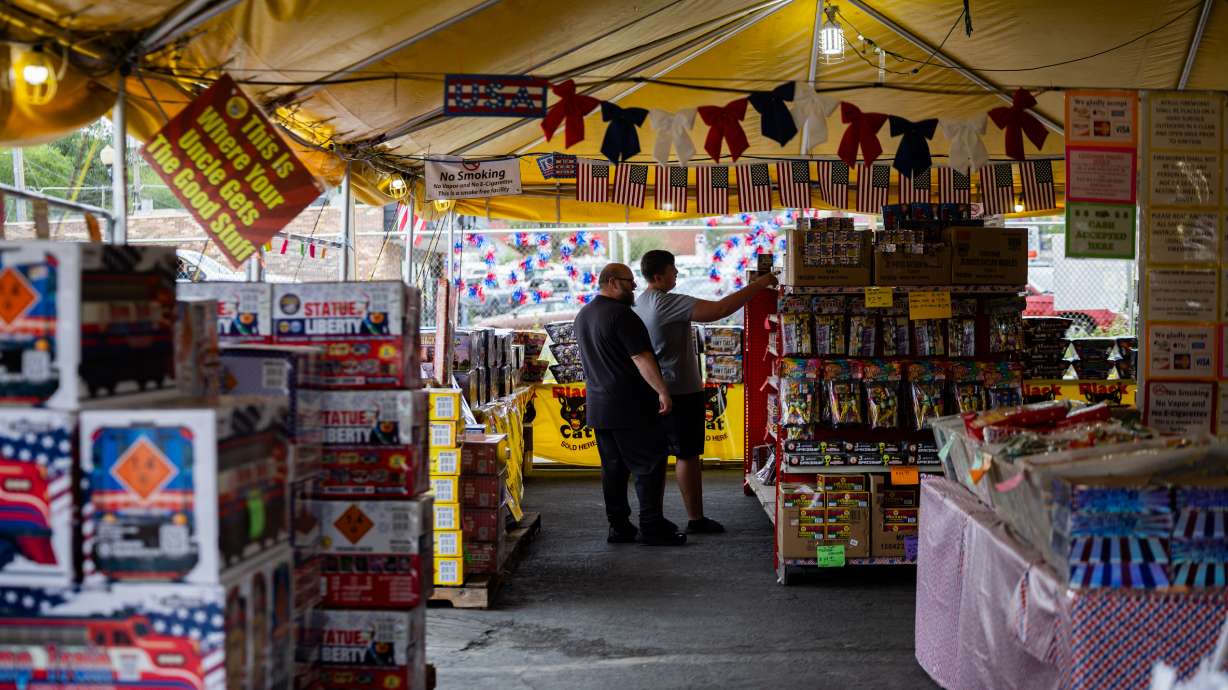 Customers shop for fireworks at Mad Matt's Fireworks in Sandy on Tuesday. The customers in the image are buying fireworks to support Mad Matt's Fireworks. They will not be using them.
