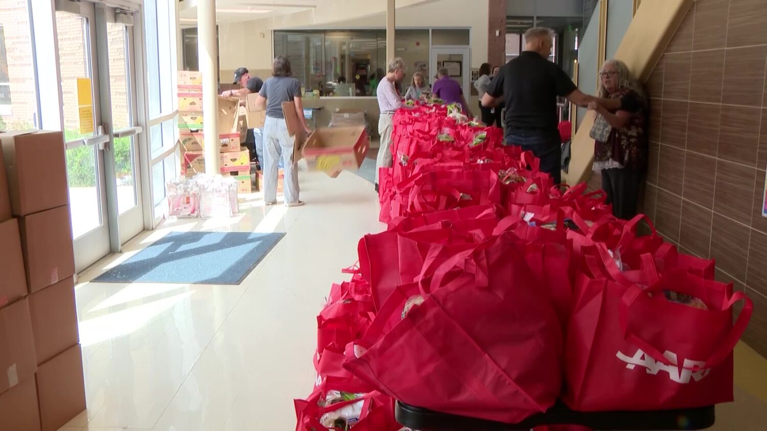 AARP volunteers team up with Utah Food Bank to feed students