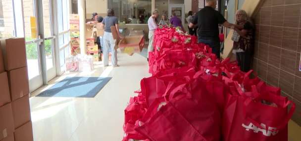 AARP volunteers team up with Utah Food Bank to feed students