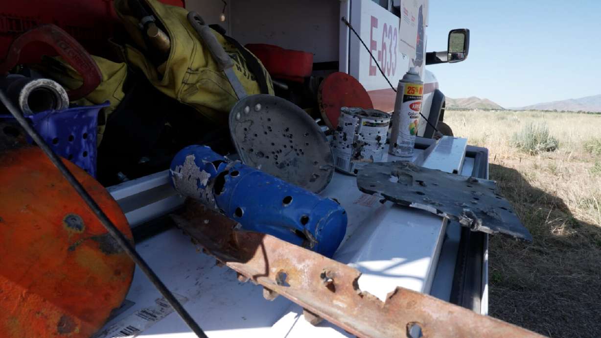 Firefighters display steel targets and a propane tank that can easily start wildfires when used in target shooting.