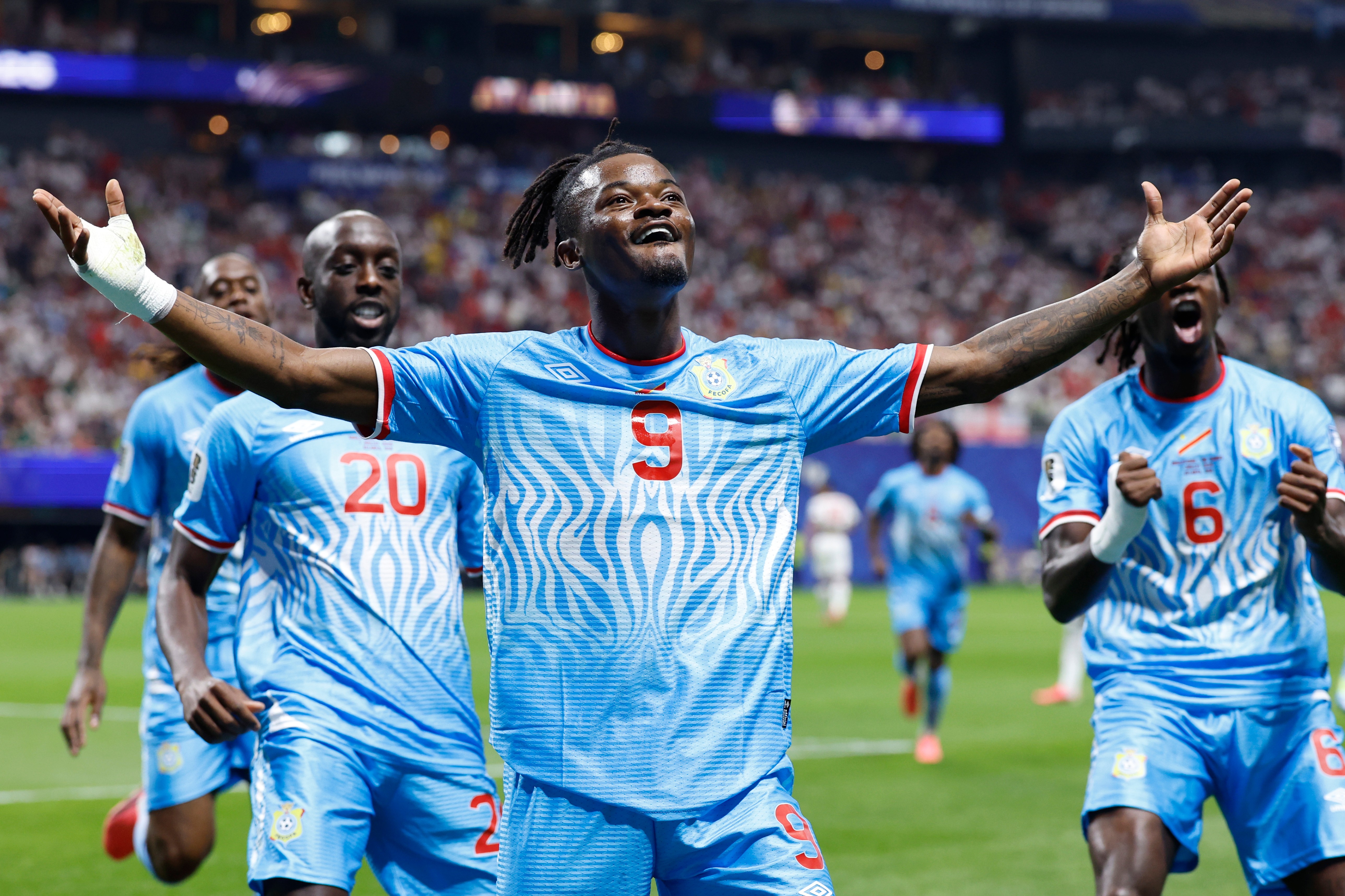 Congo's Brian Cipenga (9) celebrates with teammates after scoring their first goal during the World Cup round of 32 soccer match between England and Congo in Atlanta, Wednesday, July 1, 2026. 