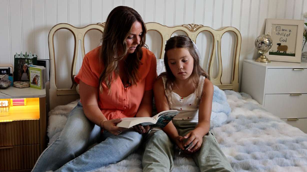 Mary Millward, mom of six, reads to her daughter on Aug. 14, 2025.