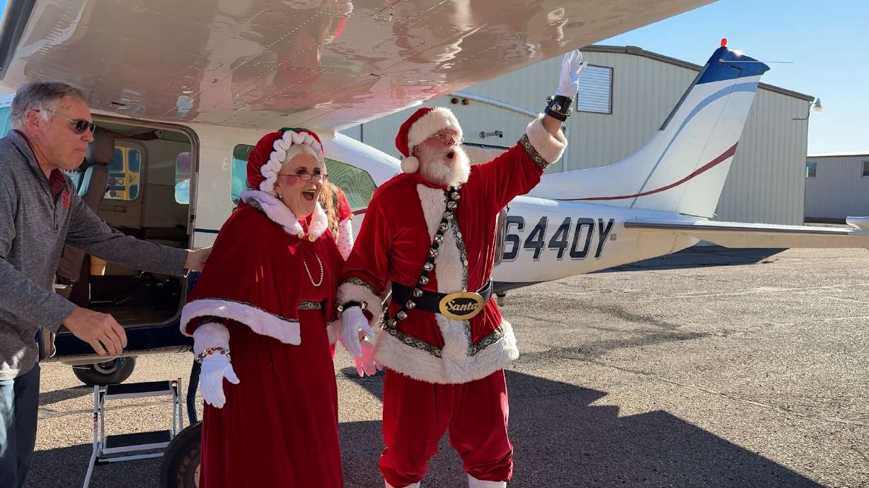 Santa and Mrs. Claus arrive by plane at the Colorado City, AZ municipal airport, Wednesday.
