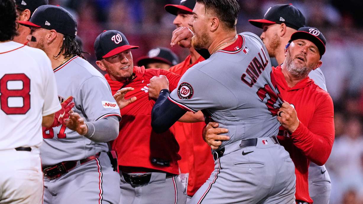 Washington Nationals' Cade Cavalli, front right, is held back as tempers flare during the fourth inning of a baseball game against the Boston Red Sox, Tuesday, June 30, 2026, in Boston.