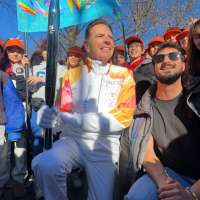 Utah 2034 Chairman Fraser Bullock runs Olympic torch in Milan, inspires thousands of students