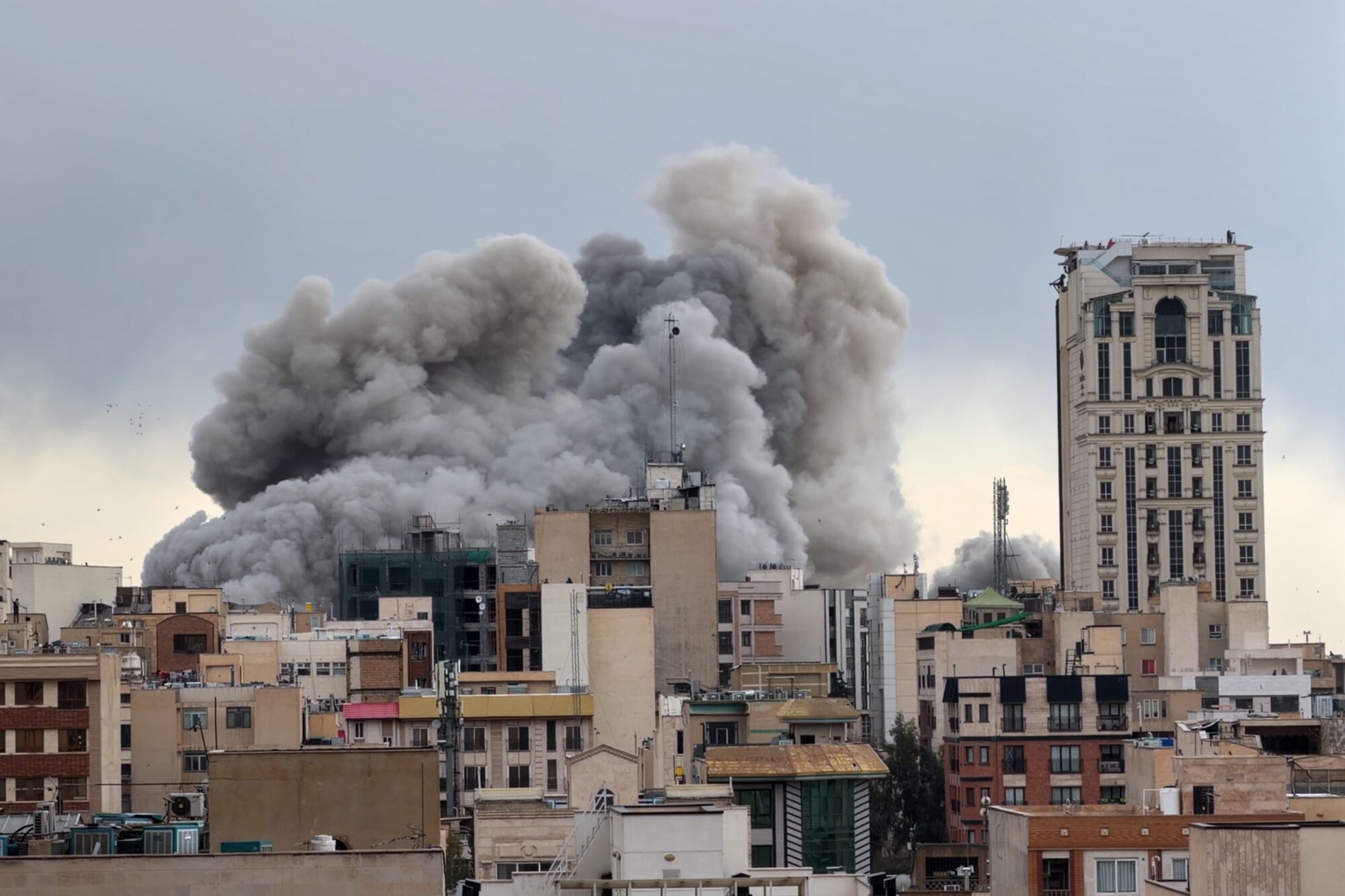 A plume of smoke rises after a strike in Tehran, Iran, Monday, March 2, 2026. 