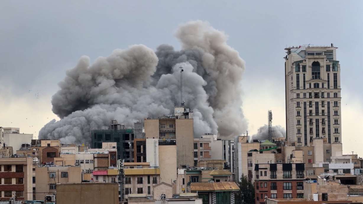 A plume of smoke rises after a strike in Tehran, Iran, Monday, March 2, 2026.