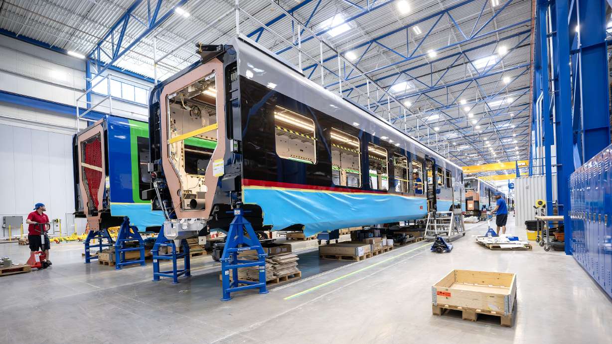 Workers assemble train cars at Stadler's Salt Lake City facility on May 29. Stadler Rail on Wednesday celebrated 10 years in the Beehive State, marked by yet another expansion to the facility and a visit from Swiss President Guy Parmelin.